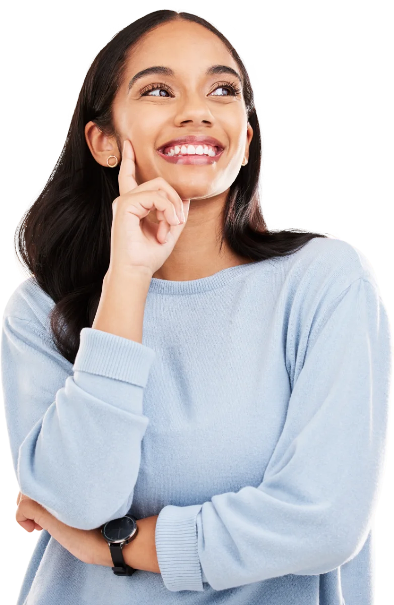 Smiling woman in a light blue sweater looking up thoughtfully with a hand on her chin.